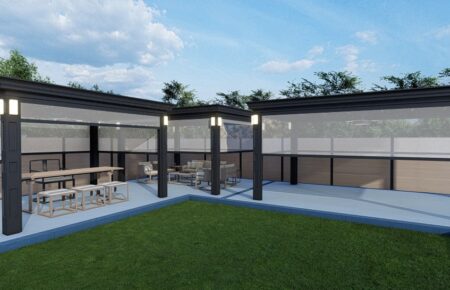 Modern outdoor patio with pergola and seating area beside a green lawn.