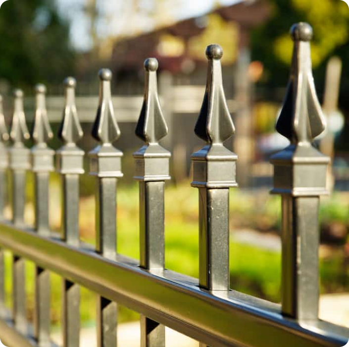 Close-up of a decorative metal fence with pointed finials.